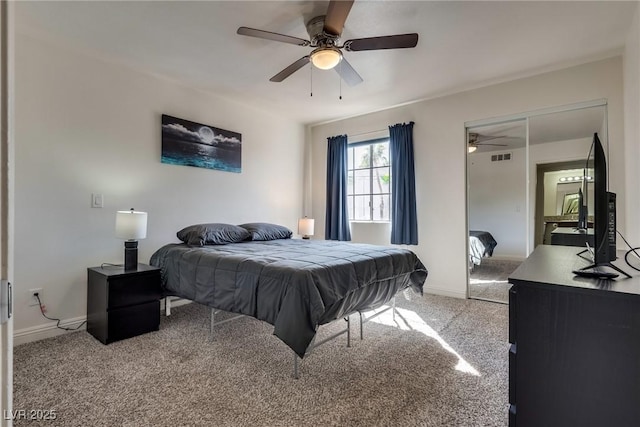 carpeted bedroom with visible vents, baseboards, and a ceiling fan