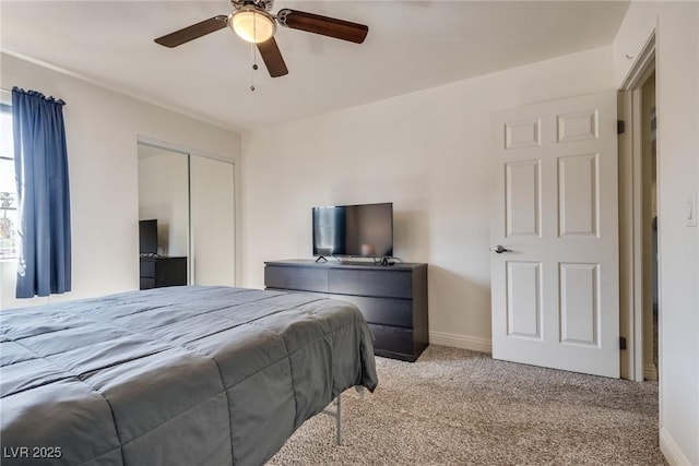 carpeted bedroom featuring a closet, ceiling fan, and baseboards