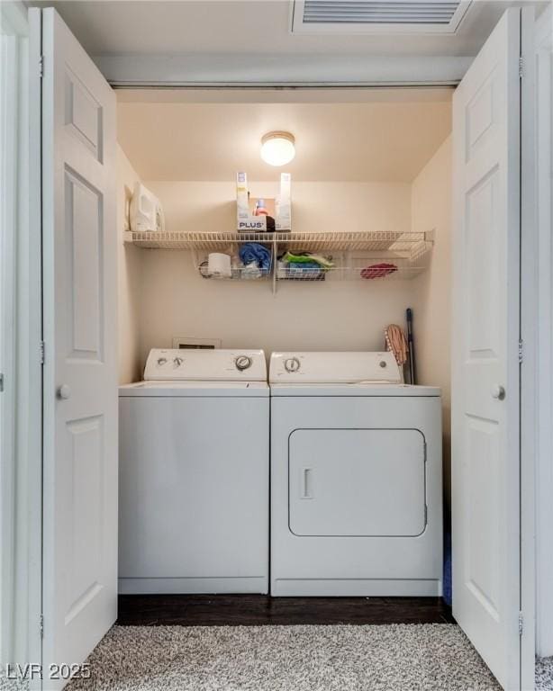 washroom featuring laundry area, visible vents, and separate washer and dryer