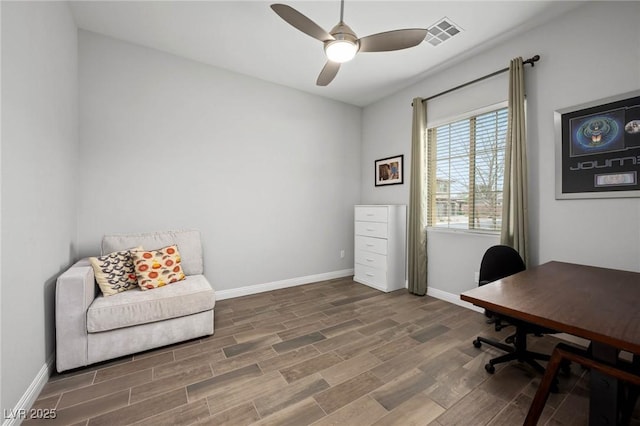 office area featuring a ceiling fan, wood finished floors, visible vents, and baseboards