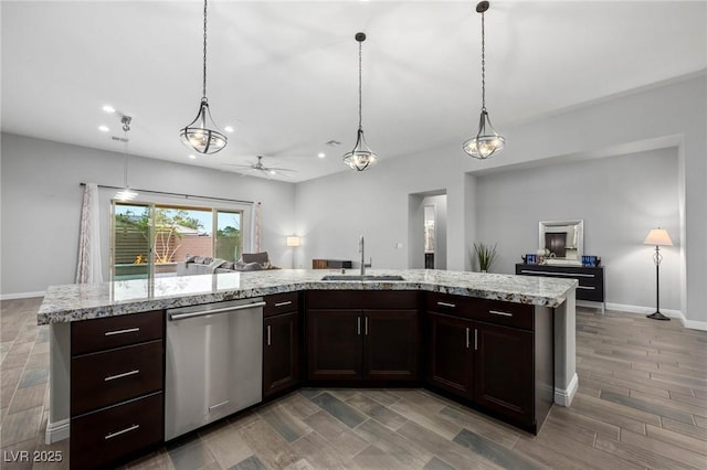 kitchen featuring open floor plan, a sink, stainless steel dishwasher, and dark brown cabinets