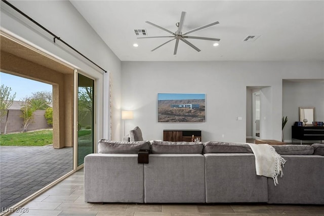 living room with ceiling fan, wood tiled floor, visible vents, and recessed lighting