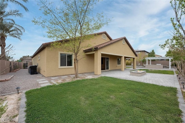 rear view of property featuring a fenced backyard, a yard, a patio area, a pergola, and stucco siding