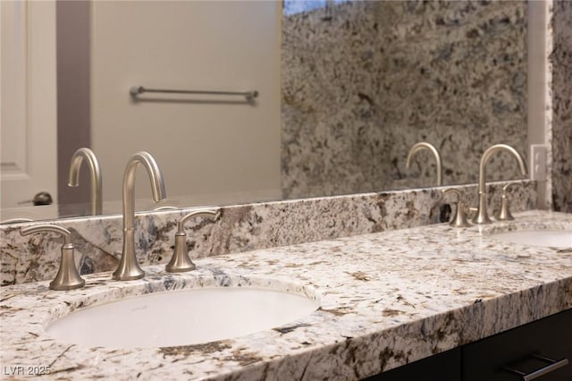 bathroom featuring double vanity and a sink