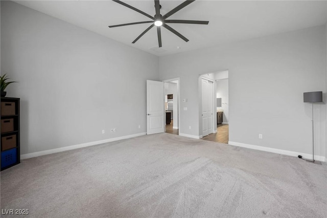 unfurnished bedroom featuring baseboards, carpet flooring, and ensuite bathroom