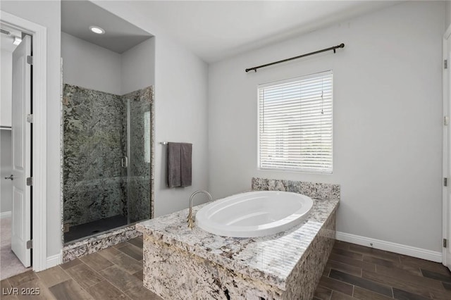 full bath with a garden tub, baseboards, a shower stall, and wood tiled floor