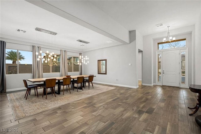 dining room with dark wood-style floors, visible vents, baseboards, and an inviting chandelier