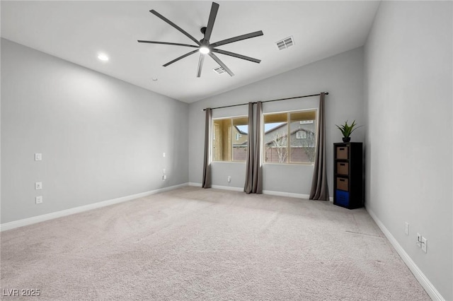 carpeted spare room with a ceiling fan, lofted ceiling, visible vents, and baseboards