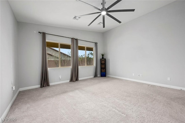 carpeted empty room featuring visible vents, ceiling fan, and baseboards