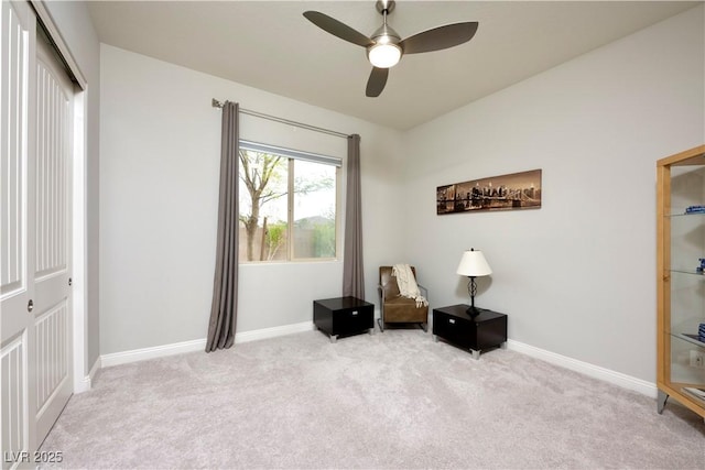 sitting room featuring light carpet and baseboards