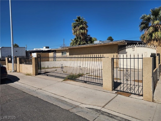 view of gate featuring a fenced front yard