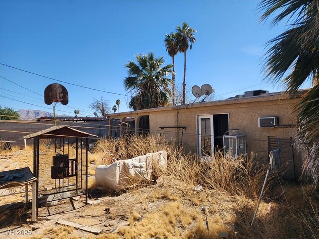 exterior space featuring fence and stucco siding