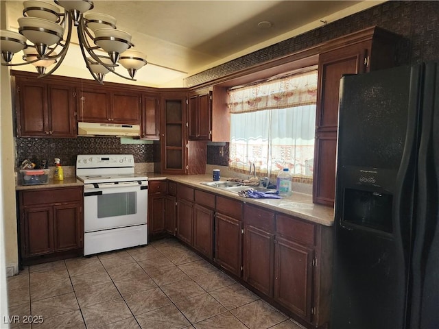 kitchen featuring light countertops, white electric range, black fridge, under cabinet range hood, and a sink