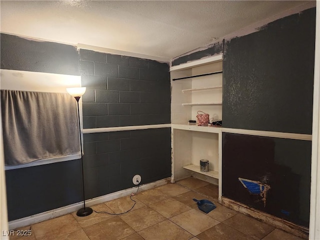 laundry area with a textured ceiling