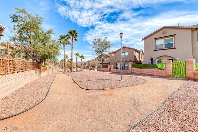 view of home's community with a residential view and fence