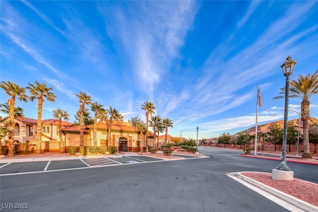 exterior space featuring street lighting, a residential view, curbs, and sidewalks