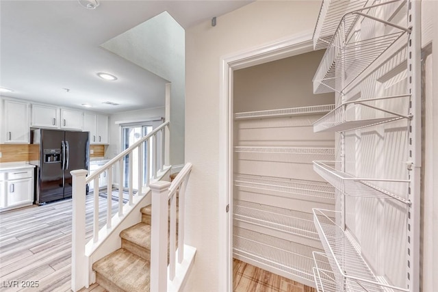 stairway featuring wood finished floors