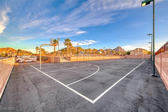 view of basketball court featuring community basketball court and fence