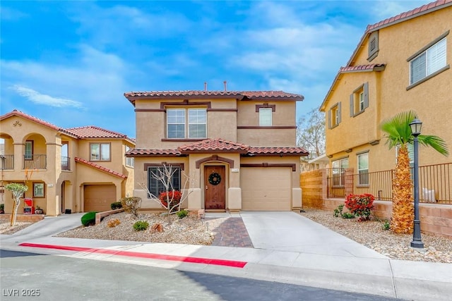 mediterranean / spanish-style house with a garage, a tile roof, fence, concrete driveway, and stucco siding