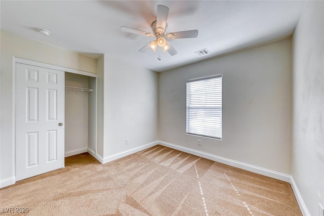 unfurnished bedroom featuring a closet, baseboards, visible vents, and carpet flooring