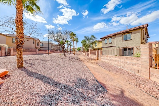 view of yard featuring a residential view and fence