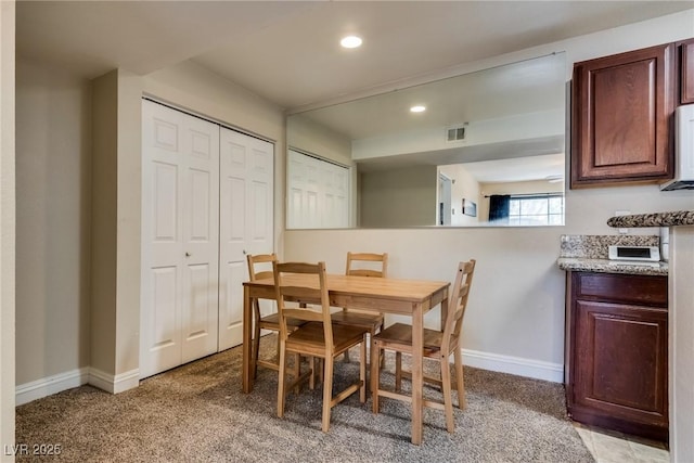 dining room with light carpet, visible vents, baseboards, and recessed lighting