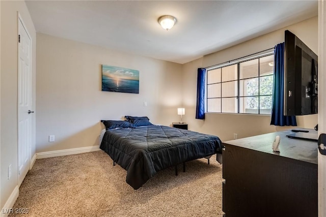 bedroom with carpet and baseboards