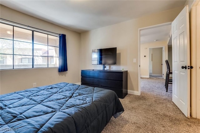 bedroom featuring carpet floors and baseboards