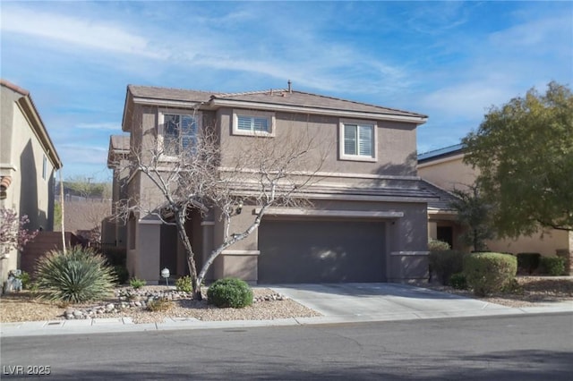 traditional home with a garage, driveway, and stucco siding