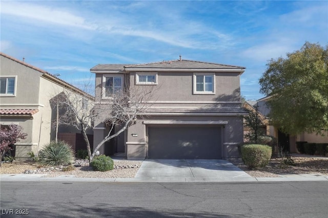 traditional-style home with driveway, an attached garage, and stucco siding