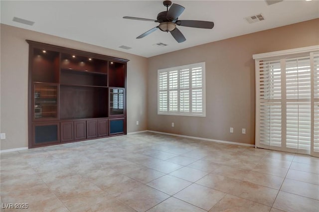 unfurnished room with light tile patterned floors, ceiling fan, visible vents, and baseboards