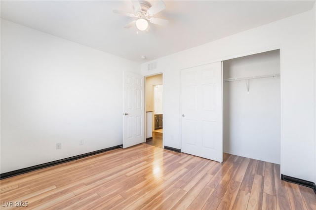 unfurnished bedroom featuring a closet, visible vents, ceiling fan, and light wood finished floors