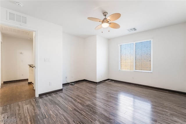 unfurnished room with baseboards, wood finished floors, visible vents, and a ceiling fan