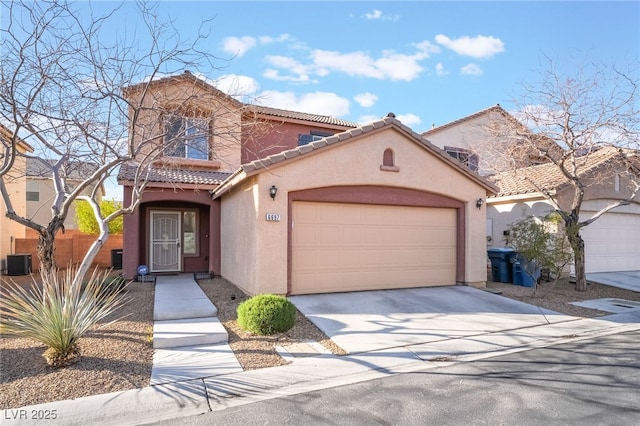 mediterranean / spanish-style home featuring driveway, a tile roof, an attached garage, central air condition unit, and stucco siding