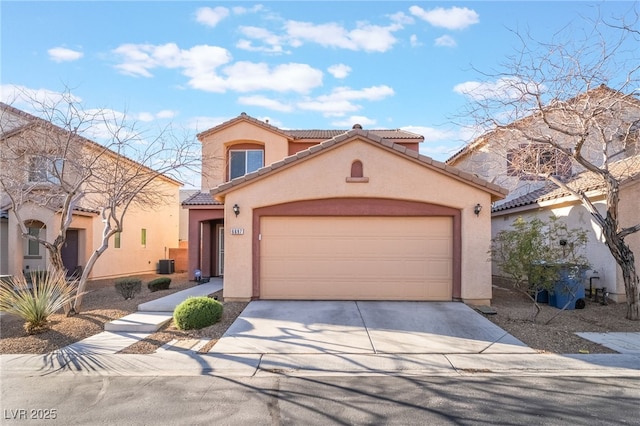 mediterranean / spanish-style house with driveway, a tiled roof, a garage, and stucco siding