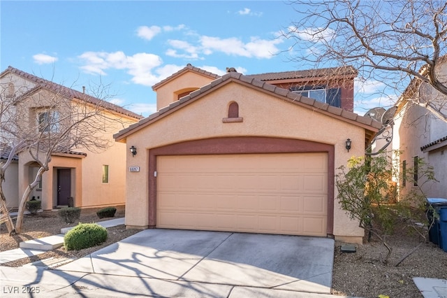 mediterranean / spanish home featuring driveway, an attached garage, a tiled roof, and stucco siding