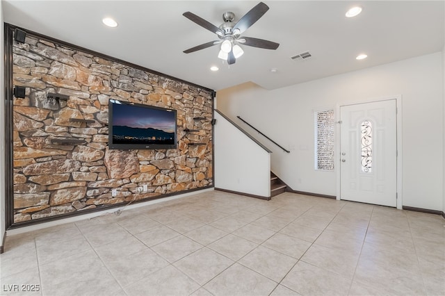 unfurnished living room with stairway, baseboards, visible vents, and tile patterned floors