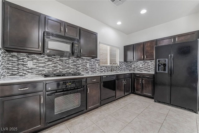 kitchen featuring black appliances, light countertops, visible vents, and decorative backsplash