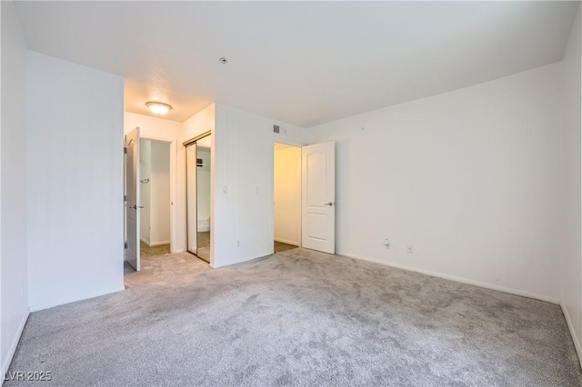 unfurnished bedroom with baseboards, visible vents, and carpet flooring