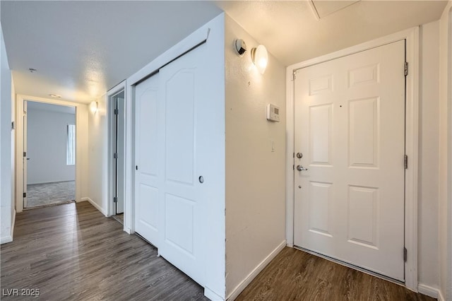 corridor with baseboards and dark wood finished floors