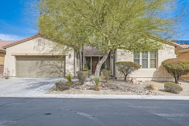 view of front of home featuring stucco siding, a garage, driveway, and a tile roof