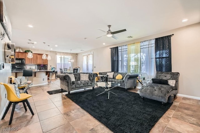 living area featuring visible vents, ceiling fan, baseboards, light tile patterned floors, and recessed lighting