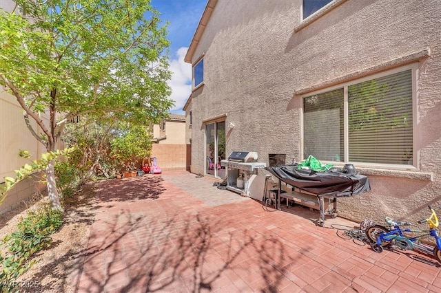 view of patio with area for grilling and a fenced backyard