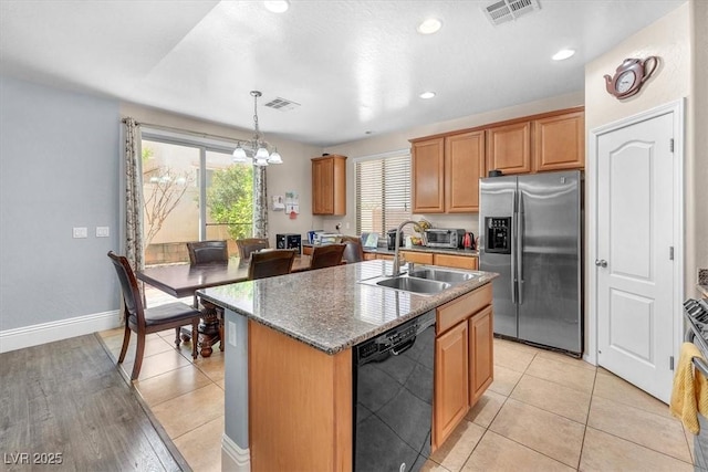 kitchen featuring dishwasher, stainless steel refrigerator with ice dispenser, a sink, and visible vents