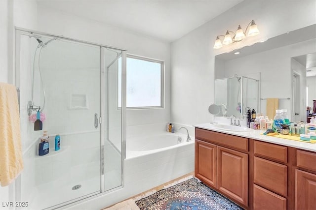 bathroom featuring a stall shower, tile patterned floors, a garden tub, and vanity