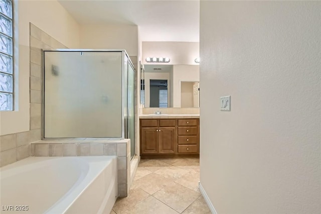 full bath with a bath, a shower stall, vanity, and tile patterned floors