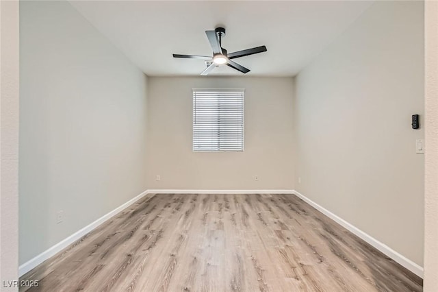 empty room featuring a ceiling fan, light wood-style flooring, and baseboards