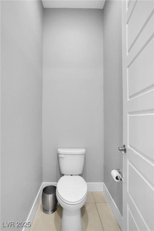 bathroom featuring toilet, baseboards, and tile patterned floors