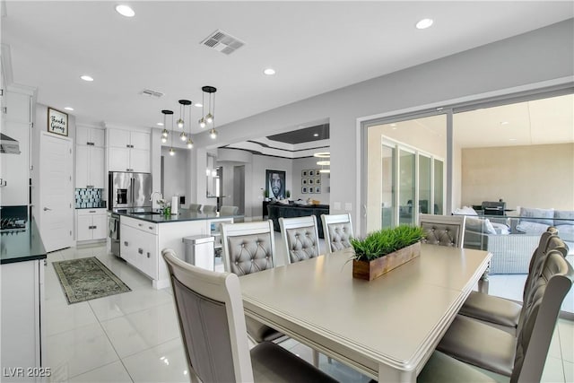 dining area with light tile patterned floors, visible vents, and recessed lighting