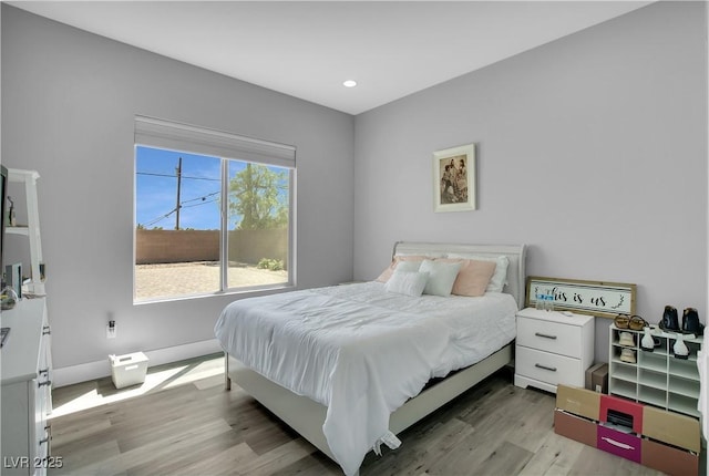 bedroom with recessed lighting, baseboards, and wood finished floors